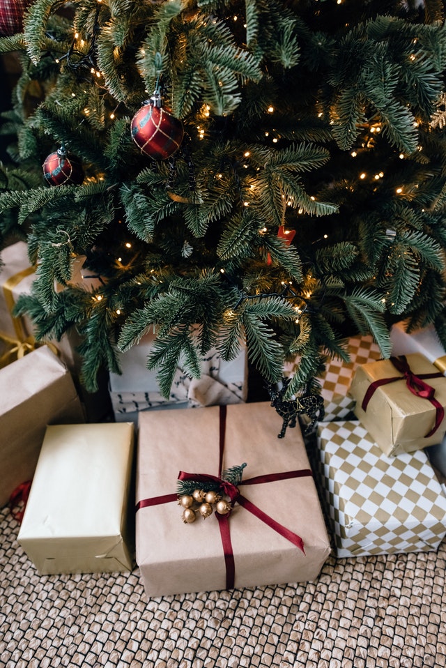 Gifts wrapped under a decorated christmas tree