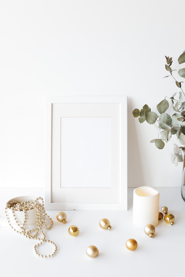 Golden Christmas ornaments against a white backdrop