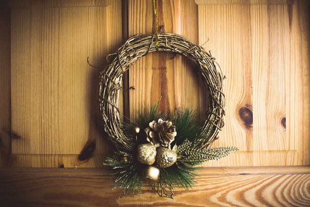 A wreath hanging on a wooden door.