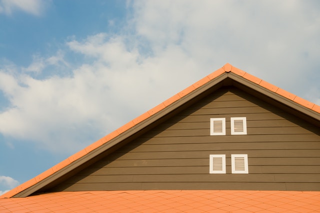 A house with a roof against a blue sky. 