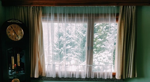A window facing snow trees