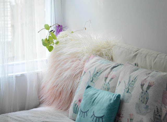 Cute fluffy pillows in pastels in a cozy corner