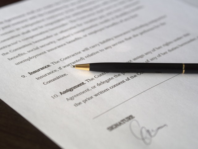 A lease agreement with a pen on top of it.