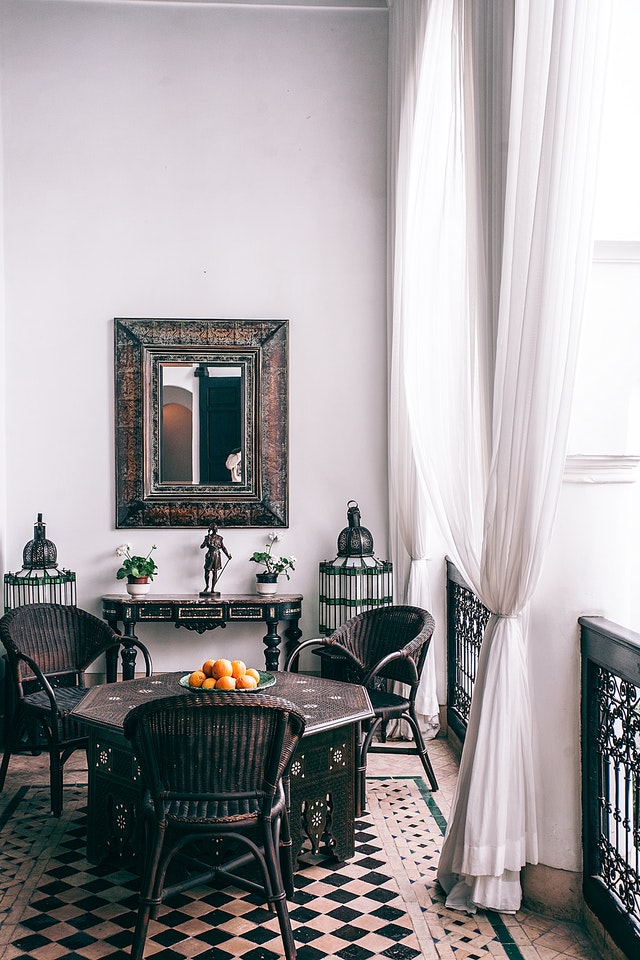 A balcony with a table and chairs