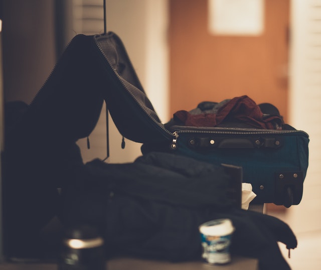 A suitcase with clothes being packed