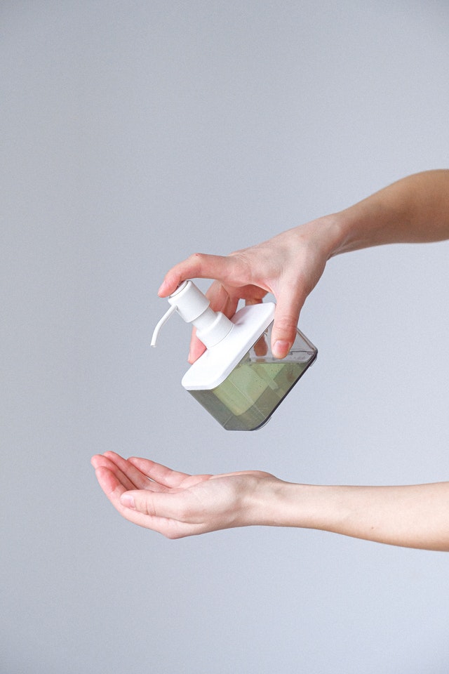 A hand using hand sanitizer