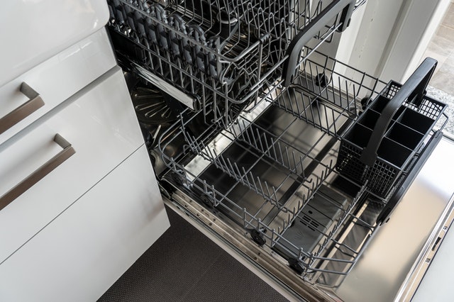 A clean, empty and open dishwasher