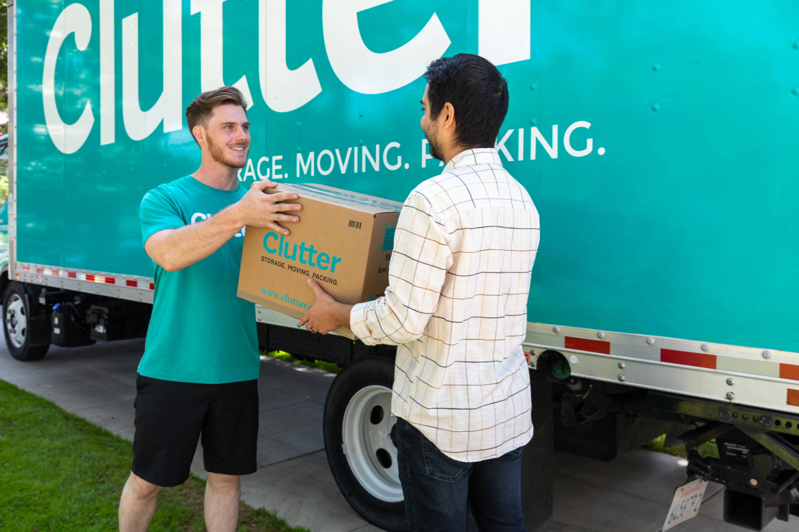 A member of the Clutter moving team taking a box from a customer.