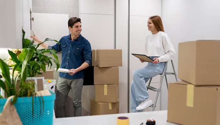 couple packing items for their summer move