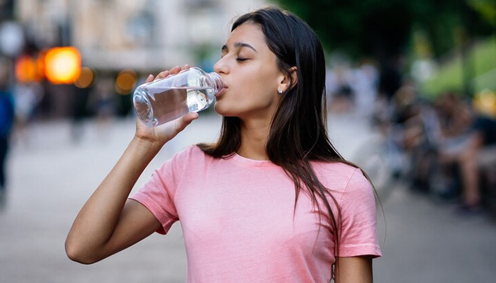 woman drinking water during