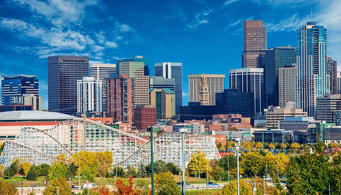 view of Denver skyline with skyscrapers and an amusement park
