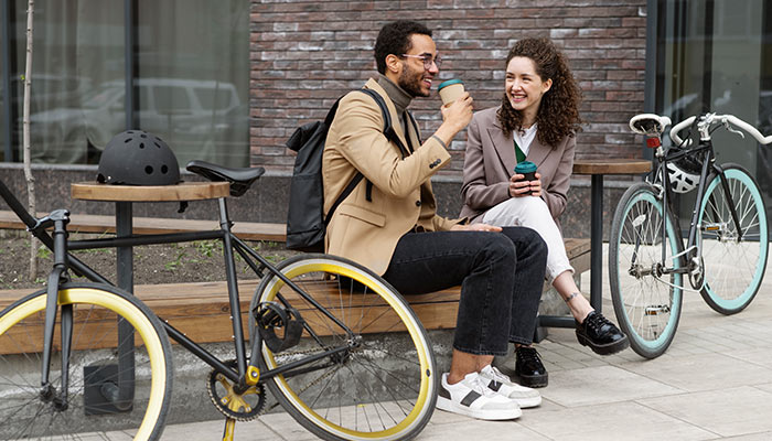 Young adults cycling to work in the city