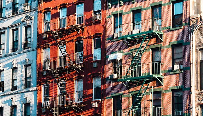 Facades of building with fire escapes