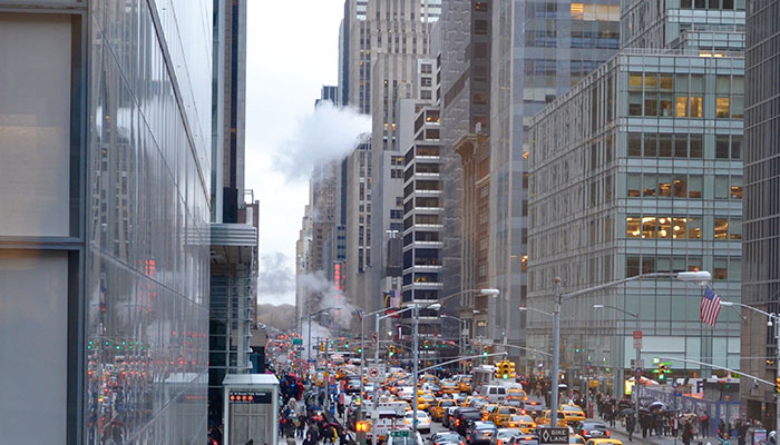 View of a busy New York Street with cabs, cars, and people 