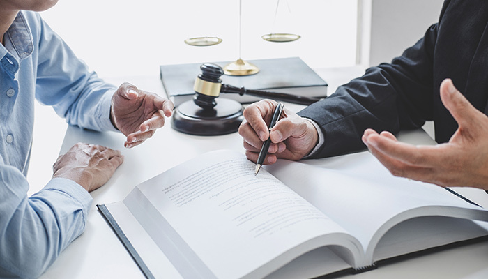 a woman taking legal consideration from a lawyer