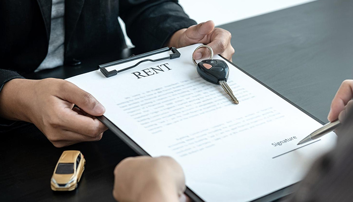 a person signing a rent agreement
