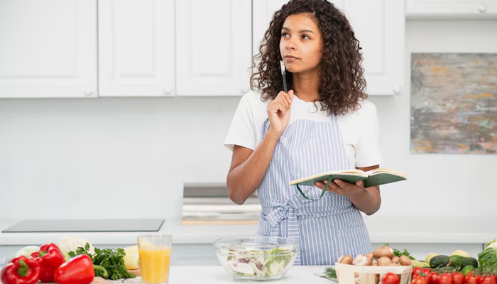 a girl is learning to cook